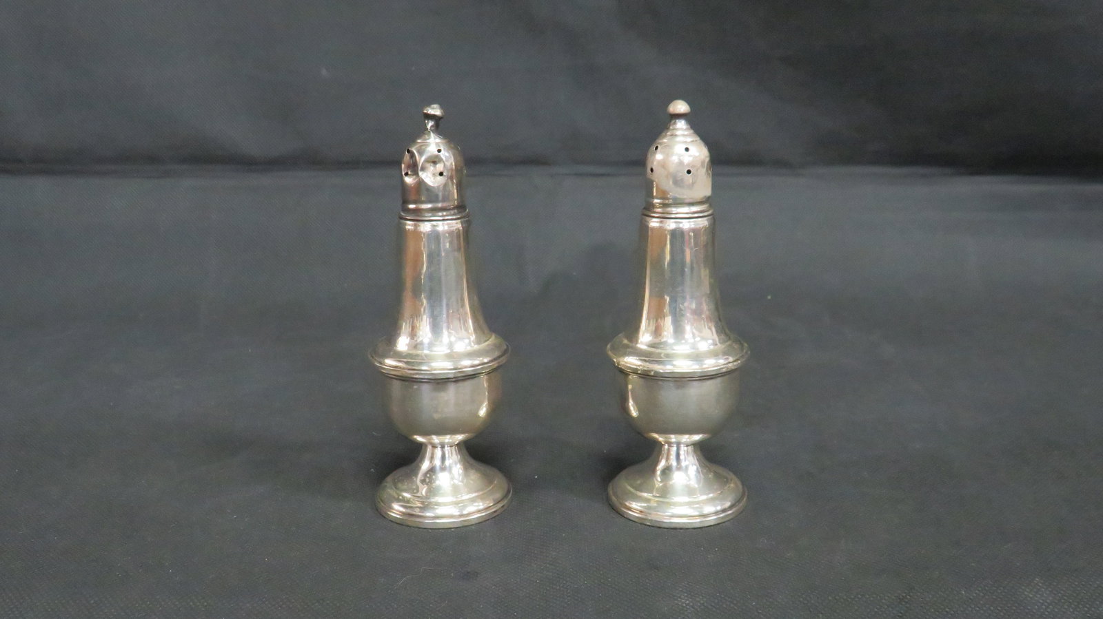 Empire Sterling Silver Salt & Pepper Shakers: Vintage Empire Sterling Silver Salt & Pepper Shakers Weighted base. Good condition with some dents. 5"H x 1.75"D