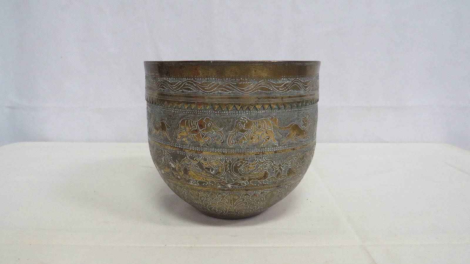 Intricately Engraved Indian Bowl circa1900: Intricately Engraved Indian Bowl circa 1900 in good condition. Hand engraved brass bowl featuring continuous animal and floral band decoration. The exterior displays detailed punch and line 