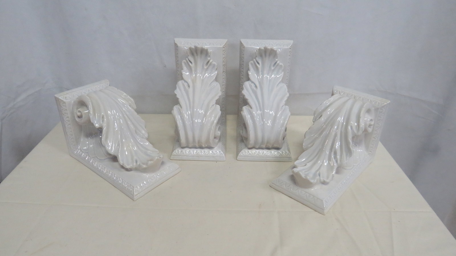 4 Large White Glazed Ceramic Corbels: 4 Large White Glazed Ceramic Corbels in good condition with some minor chips. 10"H x 5"W x 6"D