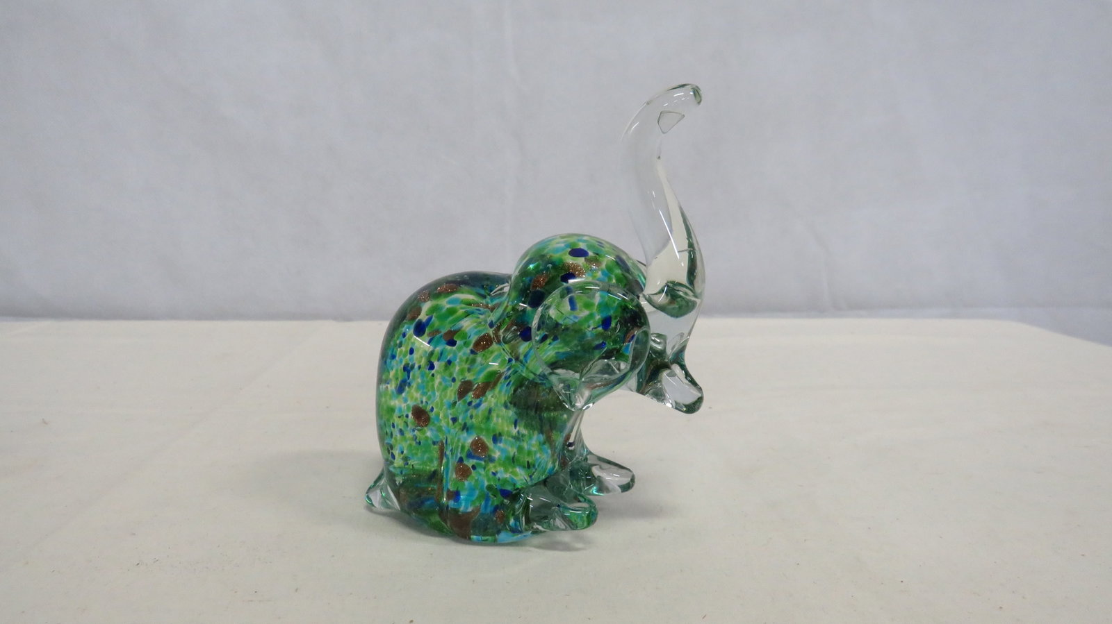 Vtg Art Glass Elephant Paperweight w/Adventurine: Vtg Art Glass Elephant Paperweight with Gold Adventurine in good condition. Blown glass with colorful confetti body and shimmering gold adventurine inclusions. 5"H x 4"L