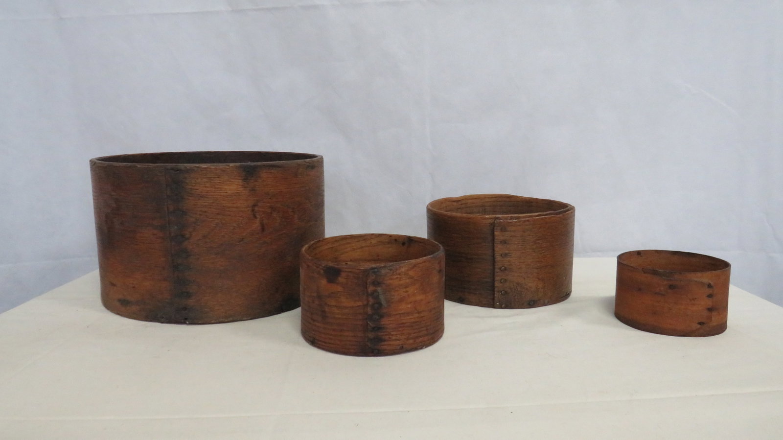 Antique Bentwood Graduated Dry Grain Measures: Antique Bentwood Graduated Dry Grain Measures. The two larger ones are signed with impressed print. Largest is illegible. Smaller one is by Frye and Sons. Good age approriate condition. Largest one