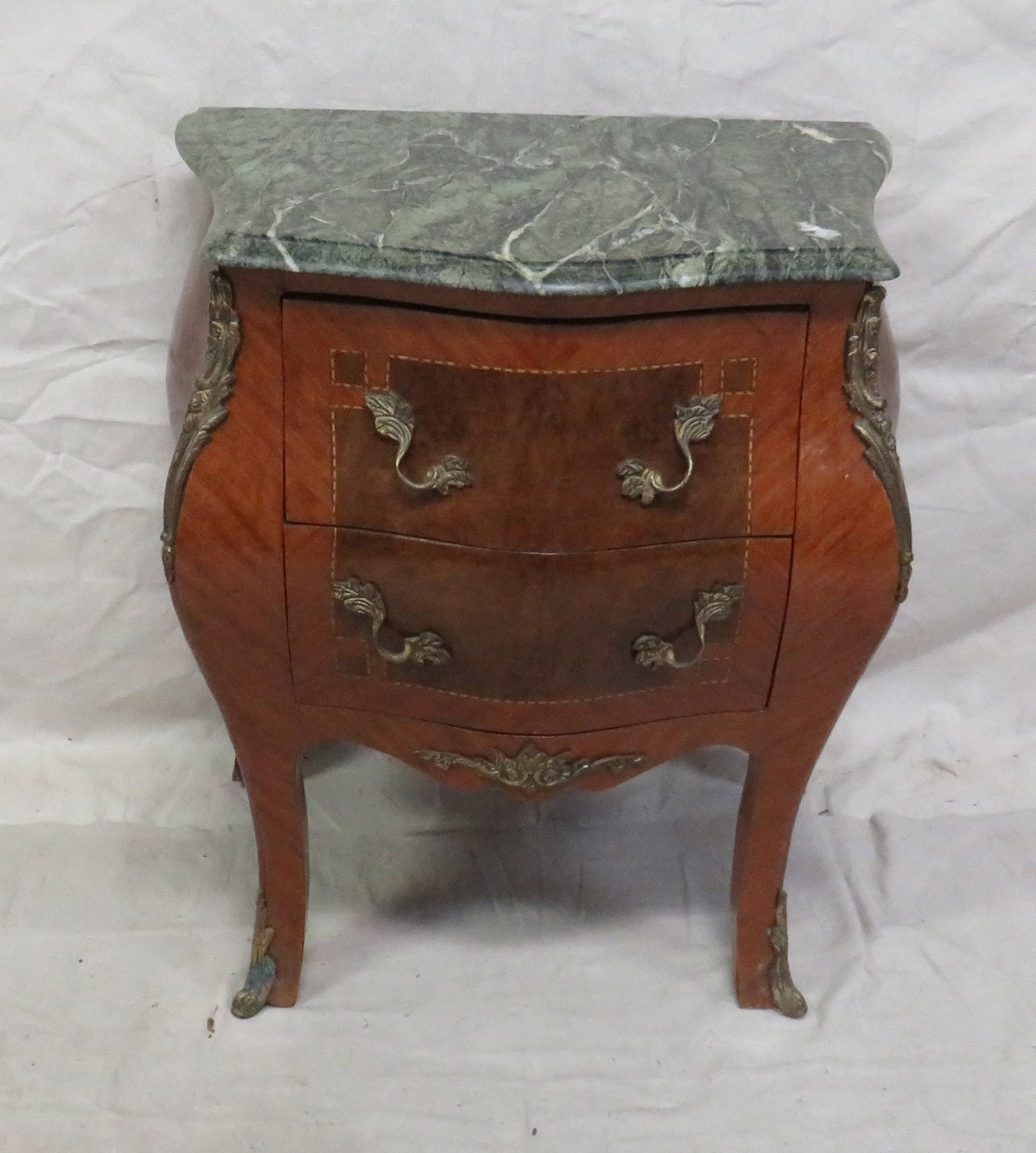 French Louis XV Bombe M/T Bedside Chest: French Louis XV Bombe M/T Bedside Chest in good condition, some veneer issues around feet, String Inlaid, Brass Ormalu, 28.5''H x 22.5''W x 15.5''D