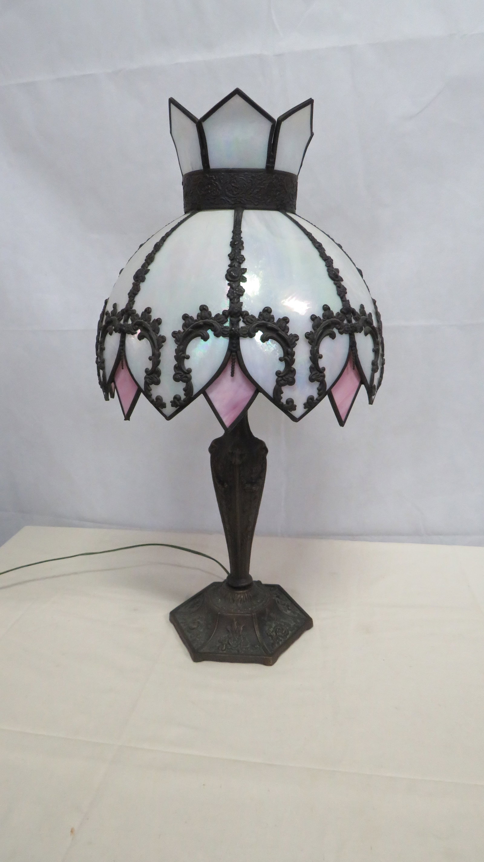 Vintage Iridescent Slag Glass Lamp: Vintage Iridescent Slag Glass Lamp in good condition. Embossed metal base with iridescent individual petals over diamond shaped pink slag glass. 26"H with 13"D shade.