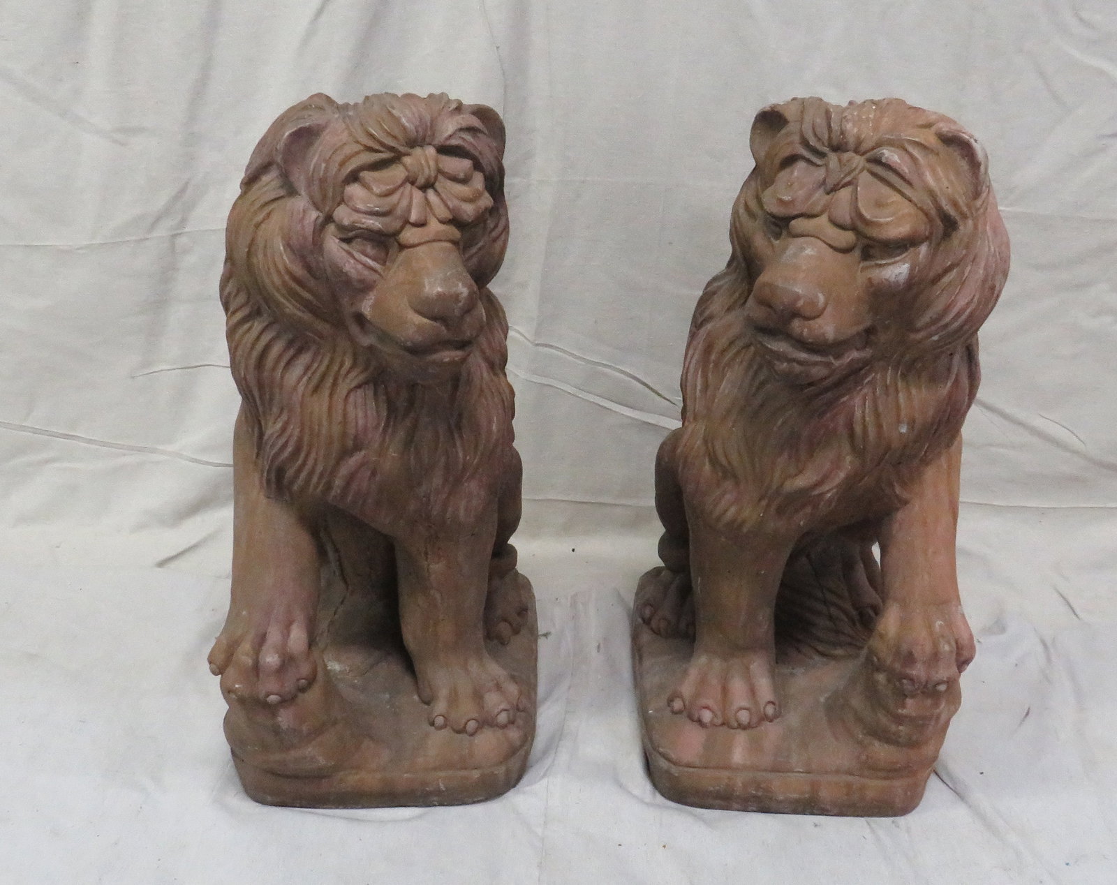 Vintage Pair Cast Stone Garden Lion Statues: Impressive pair cast stone lion sculptures- seated pose with flowing mane and expressive facial features. Natural weathered brown patina. Good condition. Sold as matched pair. 25"H x 11"W x 15"L