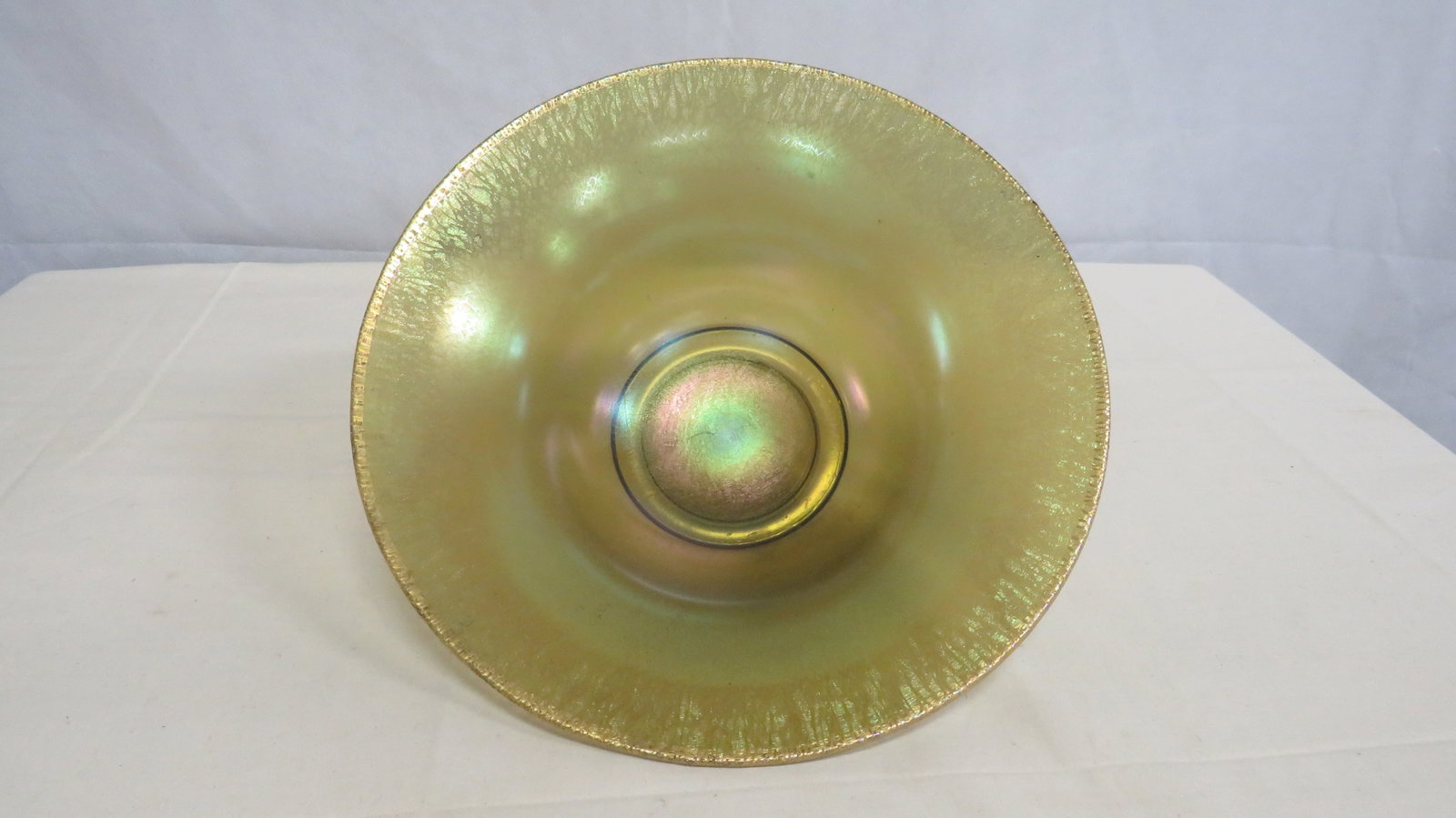Northwood Russet Iridescent Center Bowl: Early 20th-century Northwood Russet glass bowl featuring a broad flared form with a rich olive-amber body and brilliant gold iridescence with subtle pink and green highlights with finely textured surf