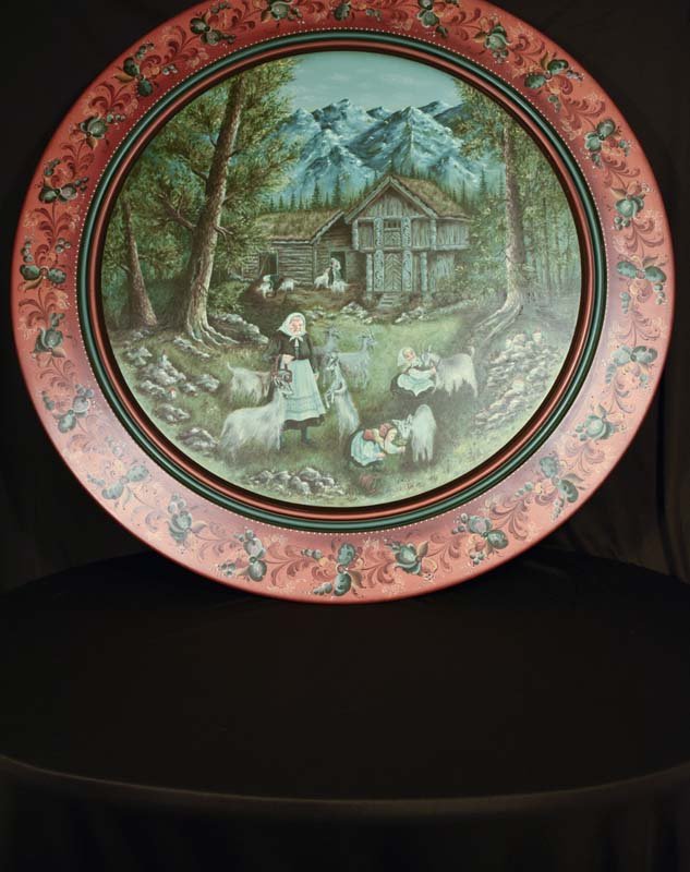 Suzanne Tofty Rosemaling Wall Painting: Fanciful scene of a cottage in the forest with women tending to goats. The background has a beautiful mountain view overlooking the forest scene. Dated 1984.