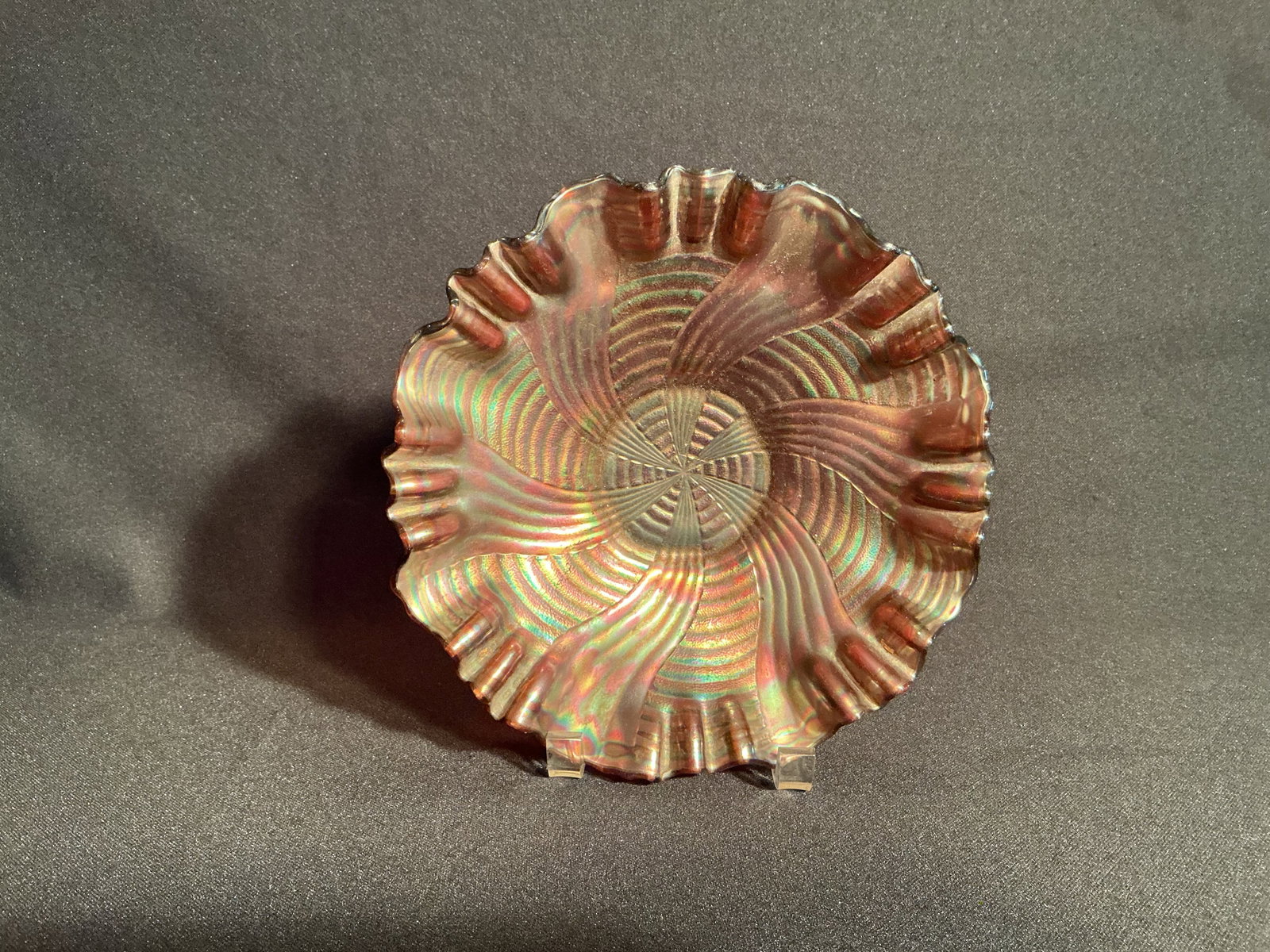 Marigold Iridescent Carnival Glass bowl: Concentric Spiraling pattern Marigold Iridescent Carnival Glass bowl with crimped edge design.