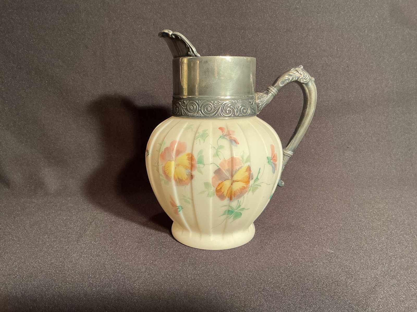 Wavecrest Pitcher with Silver Overlay: Wavecrest Pitcher with painted Pansies over an alternated vertical band design with Silver Overlay mounts for handle and spout.
