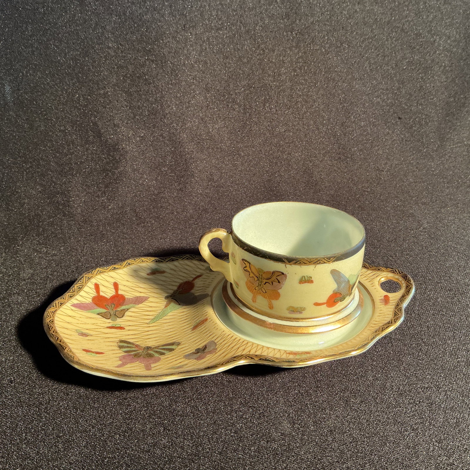 Japanese Hand Painted Cup/Saucer: Japanese Hand Painted Cup/Saucer overall gilt pattern with detailed butterfly pattern.
