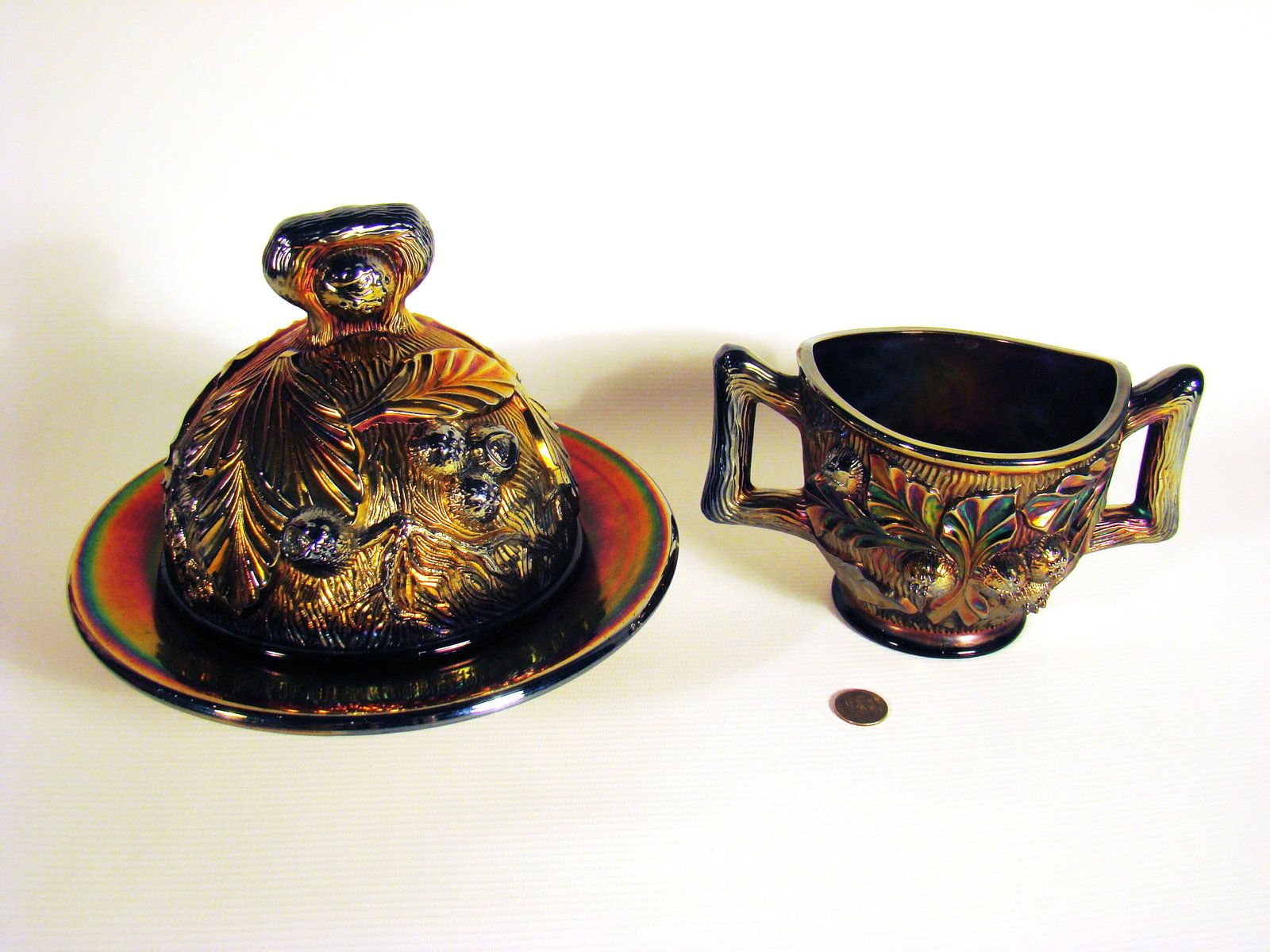 Northwood Butter Dish and Sugar bowl Carnival Glass: Berry pattern (Northwood) in amethyst. A small chip to inside rim of butter dish.