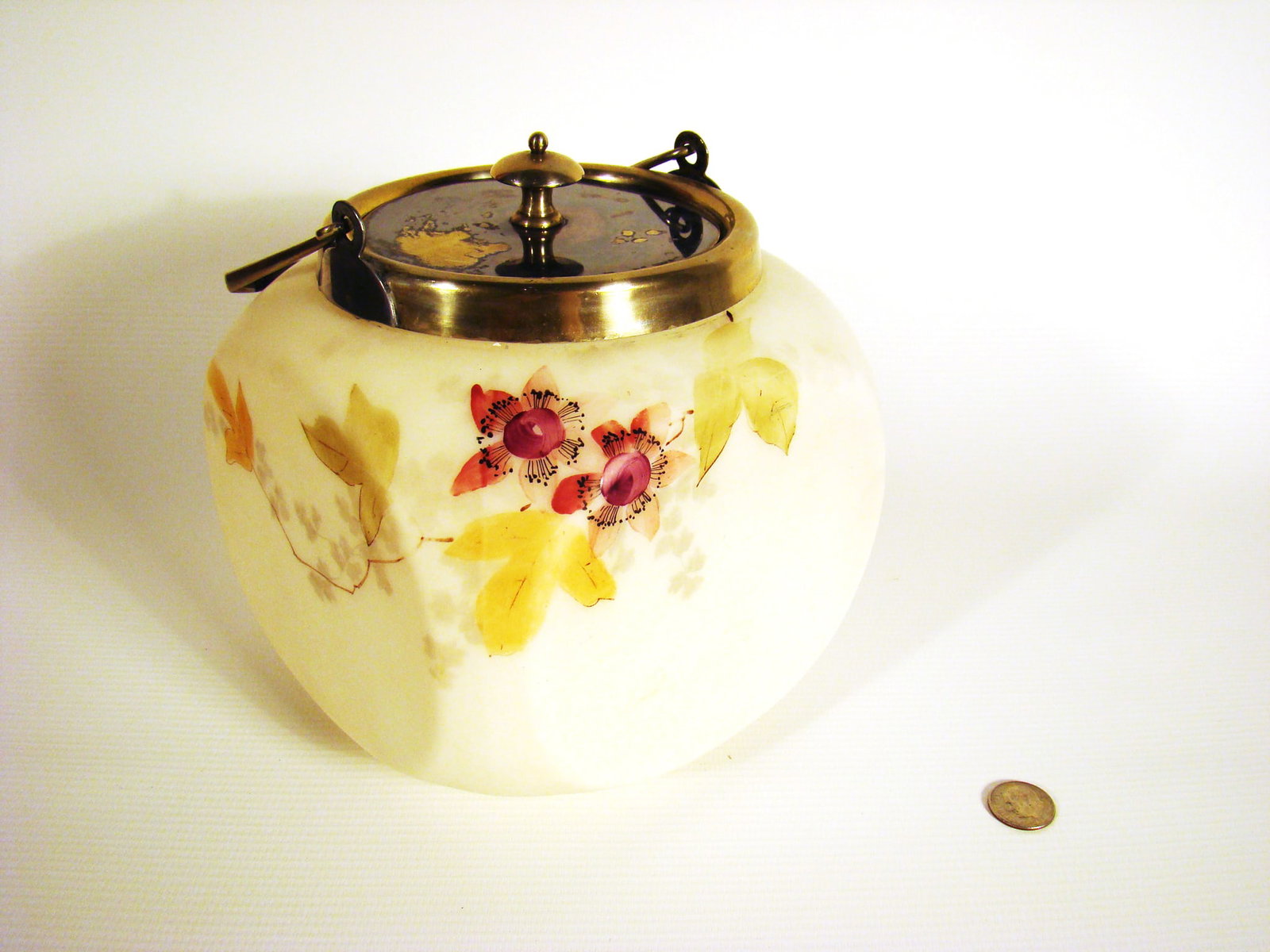 Smith Brothers Biscuit Jar: Rounded corners square form with hand-painted flowers and twigs on multiple surfaces with plated silver mounts.