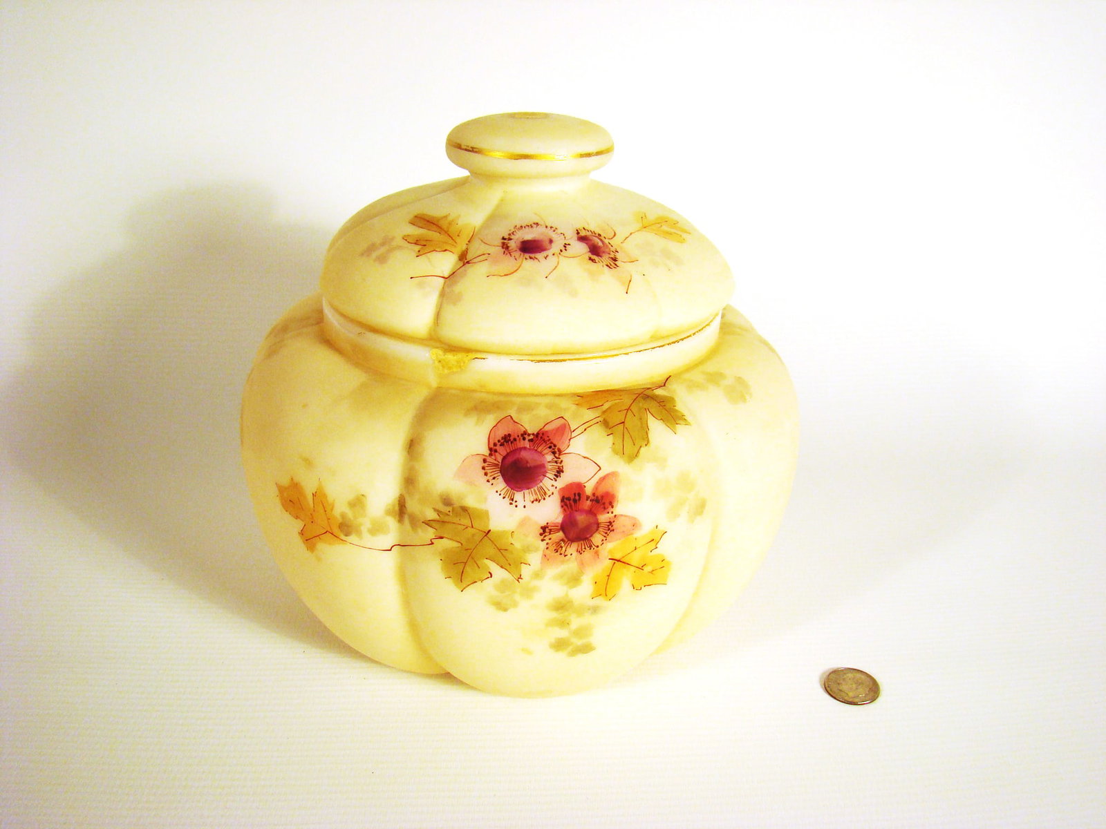 Smith Brothers covered jar: Pillow mold on body and lid with delicate hand-painted flowers and leaves that cascade from top to bottom of body. Repair to lip and light chipping inside.