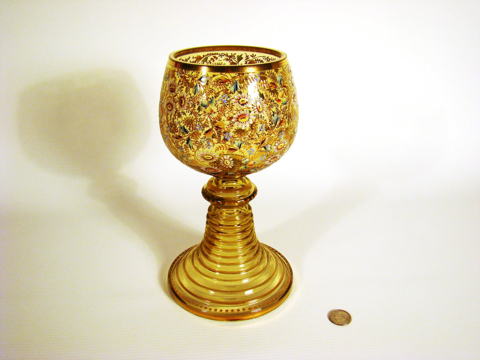 Moser Glass Goblet: Amber glass goblet with overall delicate hand-painted chintz pattern over progressive stepped up banded base.