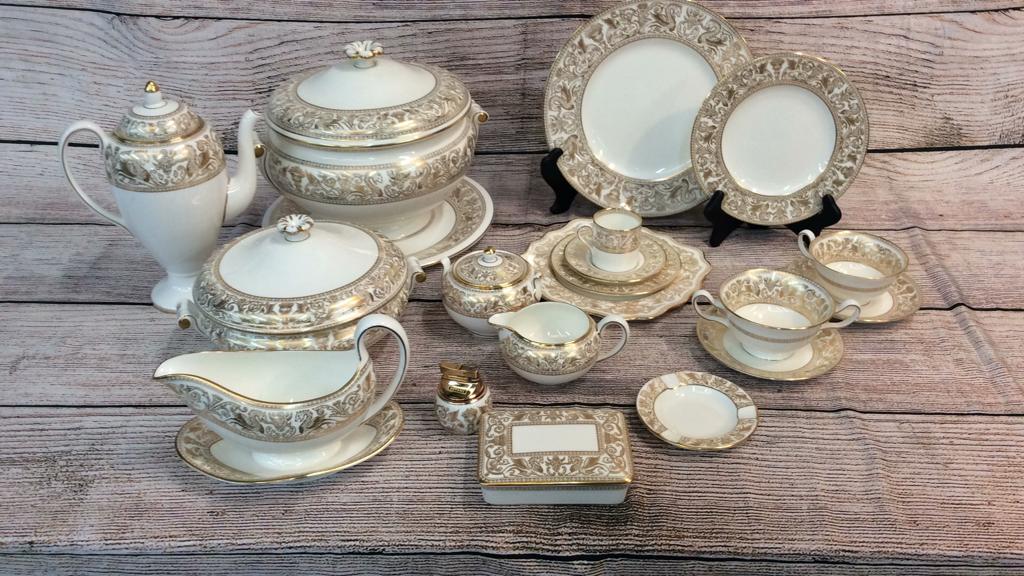 144 Pieces Wedgwood “Gold Florentine”: Including several serving and accessory pieces, 10” dinner plates, platters, tureen, Tea and coffee pots, cigarette box and ashtrays, very good condition