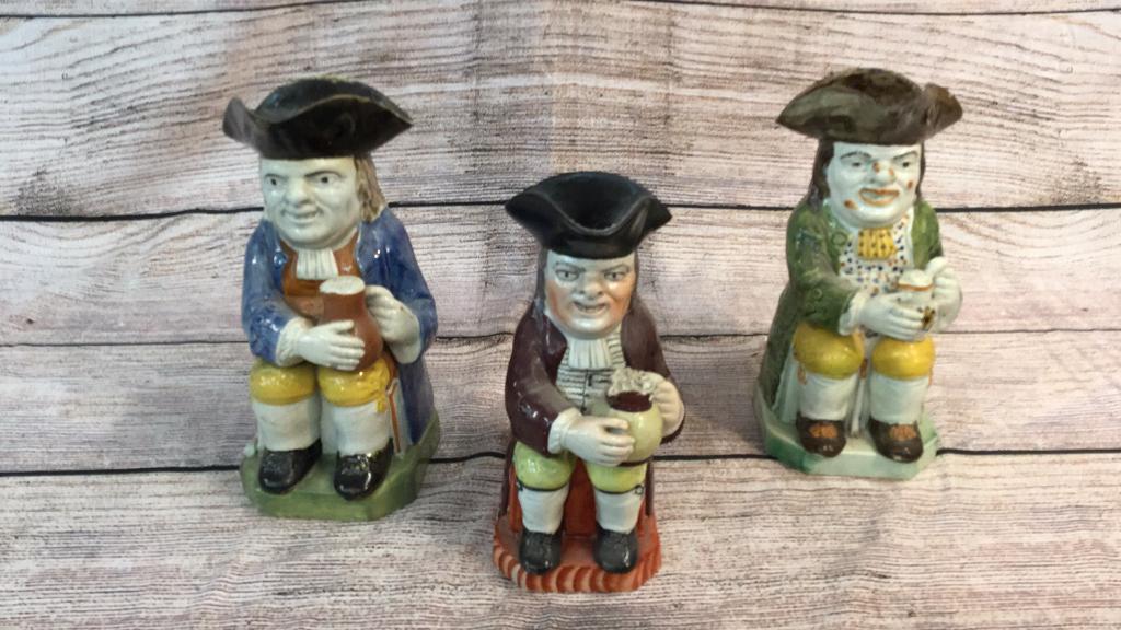Three Staffordshire Style Toby Jugs: 8 1/2” and 10” some rim chips, one hairline crack on blue Coat