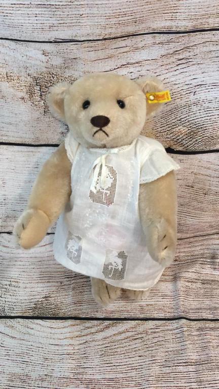 Steiff Teddy Bear: With tag and ear button, a embroidery baby dress has been added..16 inches