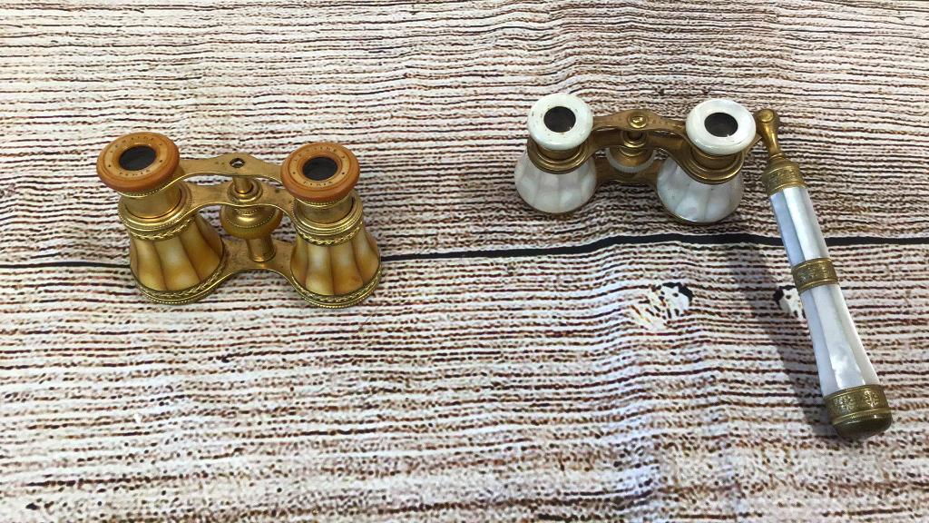 2 Pair Opera Glasses: Mother of Pearl pair with Handle...marked Paris and Iris beautiful and good condition..smaller pair in gold shell marked Lemaire and Paris...* missing a screw on the eye piece band
