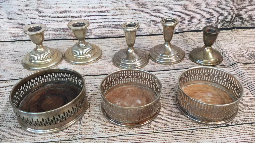 6 Assorted Sliver Items: 2 pairs Sterling weighted candlesticks, 1 singled weighted candlestick, 3 wine coasters not marked