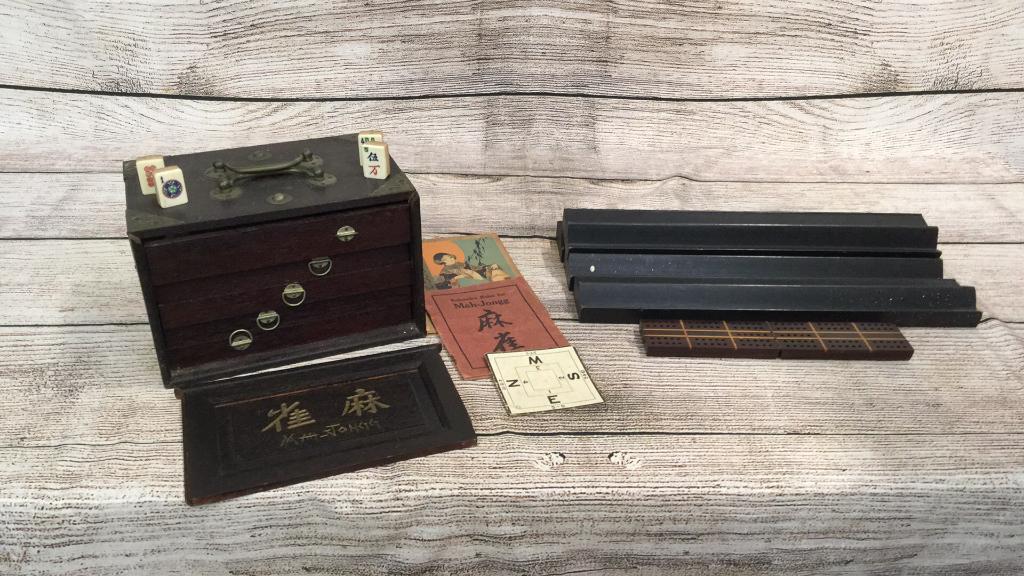 Mah Jong Set in Original Wood Case: This set is in As Found Condition ....4 drawers of tiles ..( not counted) as well as counters, trays, Rule Books...tiles are bone and bamboo....6 x 9.5 wood case with double handles, metal overlaid co