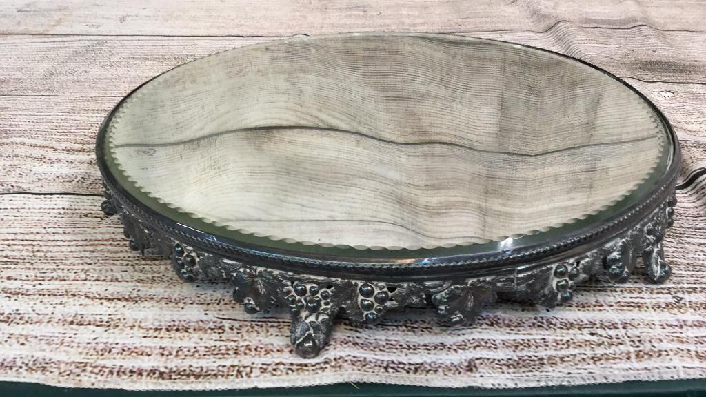 Mirrored Plateau: 14 inches with a beveled edge, plated base with grape and vine designs