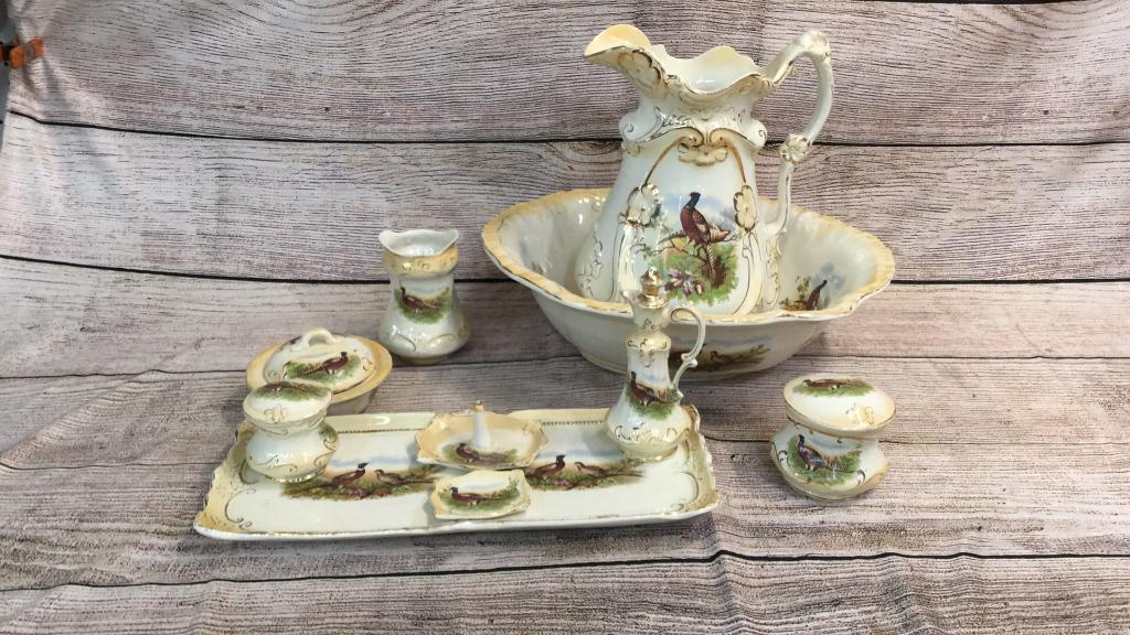 9 Piece Victorian Wash/ Vanity Set: Bowl and pitcher, soap dish, tray with scent bottle, powder jar, ring holder, pin tray, shaving brush holder....All decorated with gaming birds * normal wear..some gilt loss...line 122