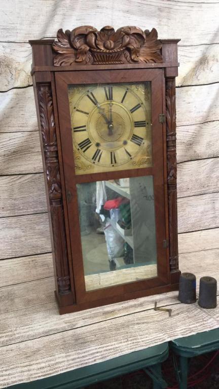 Hotchkiss Shelf Clock: 35 inches tall x 4 inches, nicely carved case with fruit basket and leaf carved posts, mirrored lower door....with pendulum and weights, and winder....line 209
