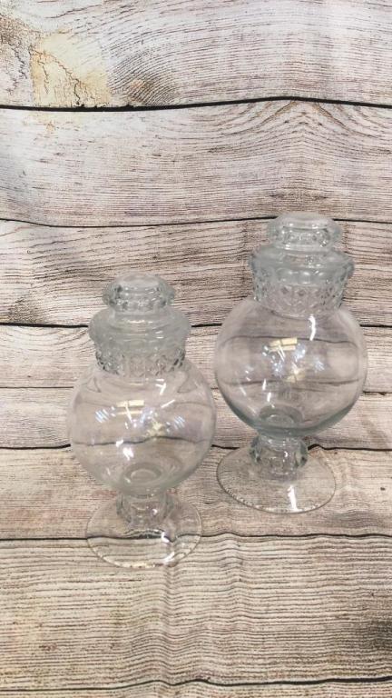 2 Antique Glass Drugstore Jars: Used for Candy or gum balls....13 and 11 inch jars with glass lid, pedestal style base...quilted cross hatched design at neck...* minor chip to rim of larger jar...(86)