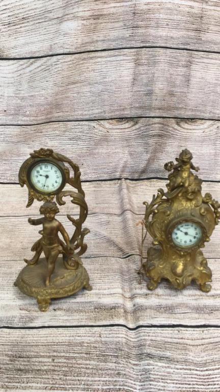 2 Petite Gilt Mantle Clocks: Both by New Haven...10 inch Puti Figural standing on shell with branch extension holding clock....10 inch French style case with Puti at crest....line 151