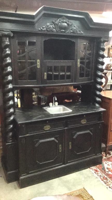 Jacobean Bar Back W Sink: Barley twist columns, carved panels, carved cornice, 93.5 tall x 65 wide x 28 deep drawers and pull out work surface have been modified to accommodate plumbing, beveled glass in upper doors