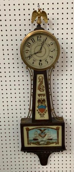 Seth Thomas Eglomise Banjo Clock: Painted Lower door with Sailing Ships, Sheild and Eagle ,brass eagle finial, lower section of case with button knob trim, painted dial, w/ key and pendulum