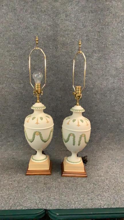 Pair Neoclassical Bisque Urn Lamps: 32 inches tall to finial....relief designs of draping and rosettes, bulbous form urns on square base, wood plinth ....green, toffee colors on antique white