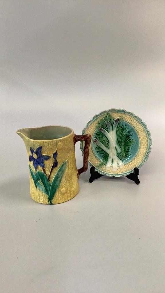 Majolica Pitcher, Asparagus Plate: Nice 8.5 inch tall pitcher with bark handle, Iris flower and daisies on yellow ground..9 inch asparagus plate with basket weave Rim, sauce well...both good condition