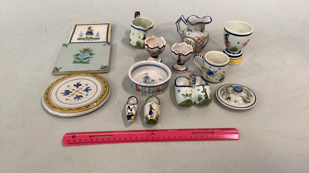 13 French Faience Quimper Articles: 3 tile trivets, 21/4 inch cup,3.5 inch miniature pitcher, 3 egg cups..2 and 4 inches….2 single shoes, one double, ramekin…* some chips, wear to pieces….