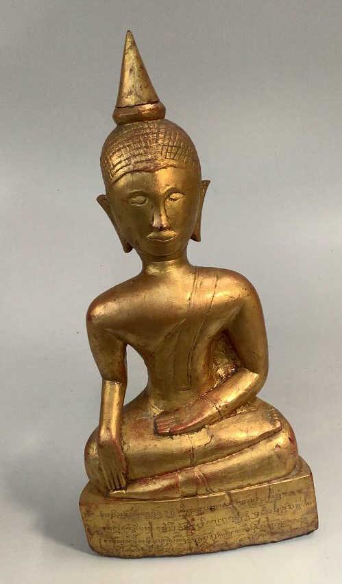 Gilt Painted vintage Buddha: Thailand, 19 inches tall, wood with a red and gold washed paint..he sits with open hand of teaching…script on base