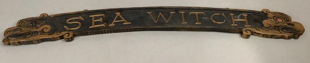 Wooden Trade Sign: 40 inch carved Trade Sign…’Sea Witch’, a washed blue with gold letters…..animalistic carved heads at each end