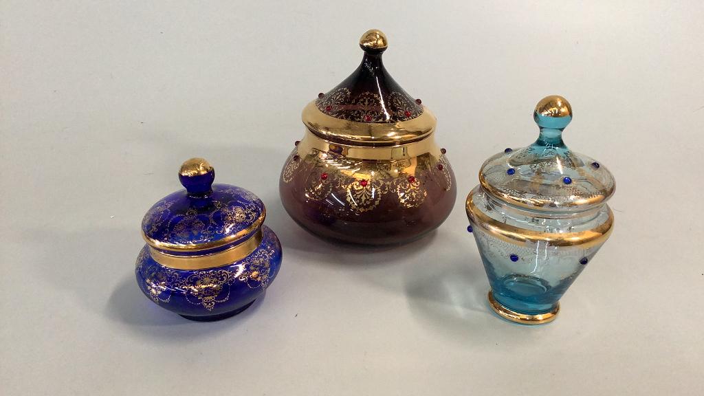 3 Pieces Bohemian Czech Art Glass: Lidded dishes in blue, light blue and purple…all with gilt trims..good condition