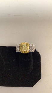 14 k White Gold, Diamond Ring: Canary radiant cut center Diamond with 2 princess cut Diamond at shoulders…surrounded with small diamonds …center stone .075ct estimated, shoulder diamonds 0.60ct estimated approximately 66 round