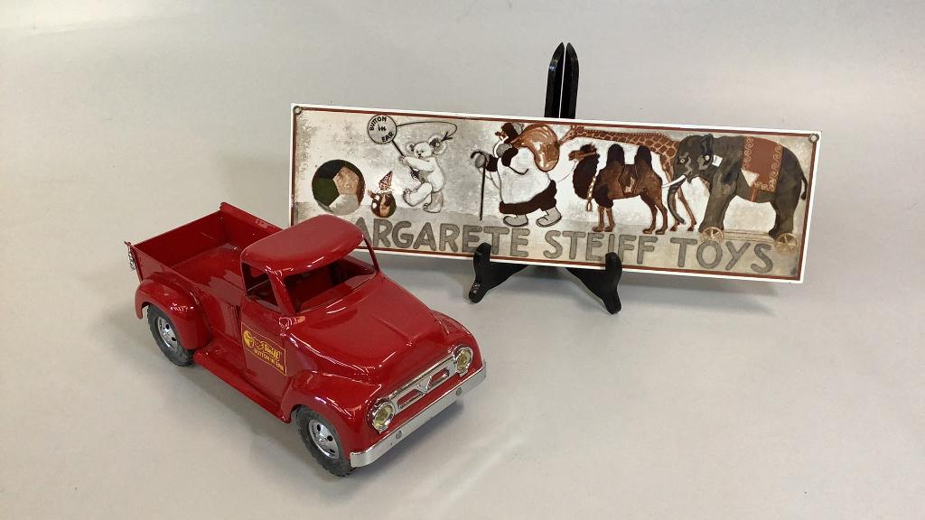 Stiff Delivery Truck, Porcelain Sign: 13 inch DeSalle Tonka Truck, In Red Paint for Steiff, produced in 1997 was sold as a set w/ delivery Bear ( not included), 19 x 7 inch one sided porcelain sign for Margaret’s Steiff Toys…b
