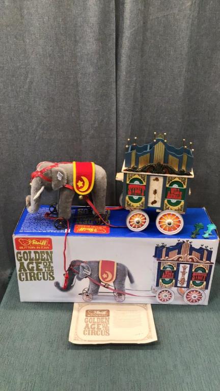 Steiff Circus Elephant and Calliope Wagon: 1988 Limited edition..EAN 0135/22..elephant is 9 inch tall on wheels..grey mohair..red harness with bell and studs..felt wool saddle blanket..red pull string..Wagon is 10 inches long x 13 inches high.