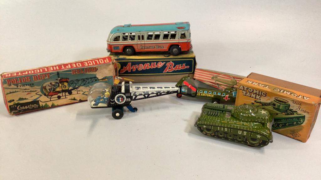4 Japan Tin Friction Toys: Atomic Tank, Police Helicopter, Small Air Force Copter, Avenue Bus…all with boxes…toys in good condition, boxes has storage damage