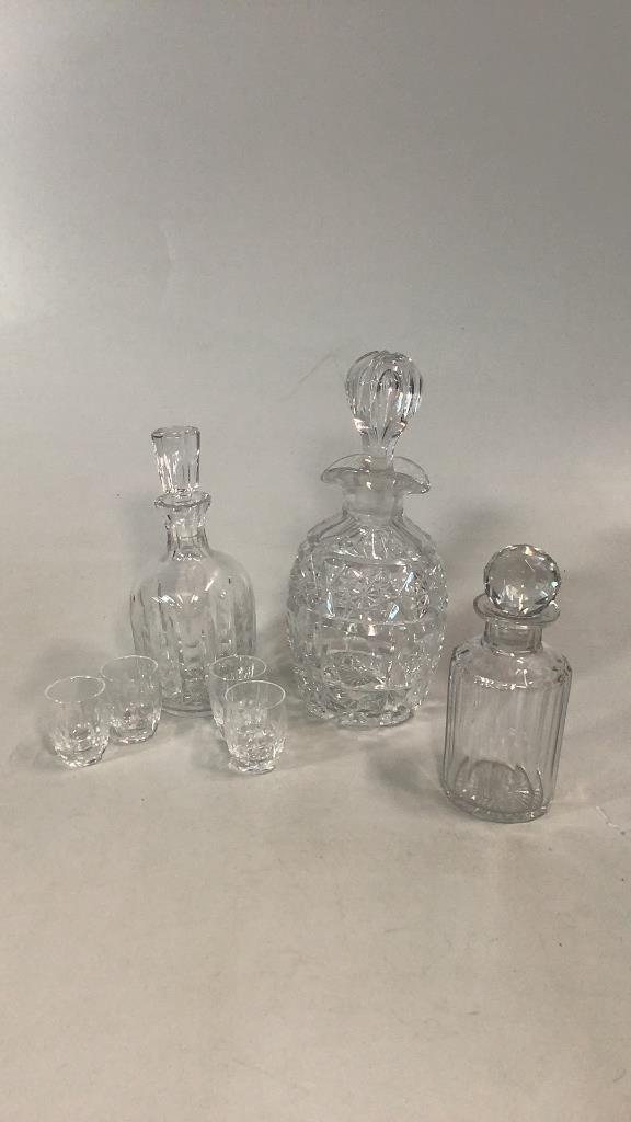 3 Crystal And Cut Glass Decanters, 4 Shots: 11 inch tall decanter with double spout, paneled stopper, 7 inch tall round decanter with facet stopper, 9 inch tall cut decanter with 4 shot glasses..no marks Line Item # 65