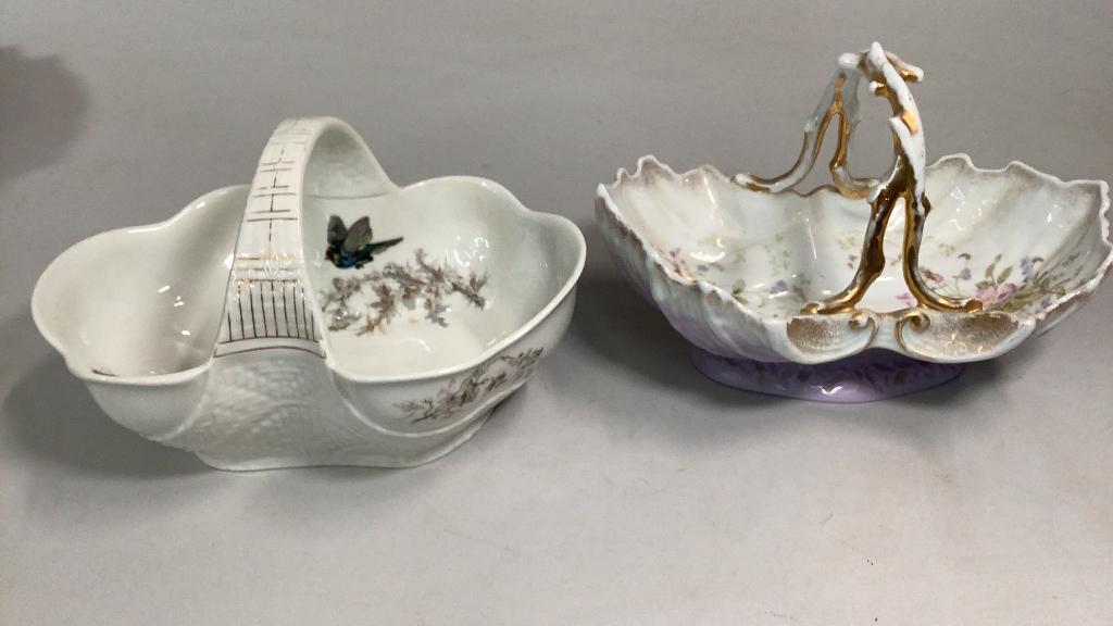 KPM Table Basket, Limoge Basket: 10 inch KPM basket with tree branch handle, shaded lavender base, floral interior, 11 inch Limoge table basket with bird and butterfly, woven design body and handle, registry mark at base, dated 1879