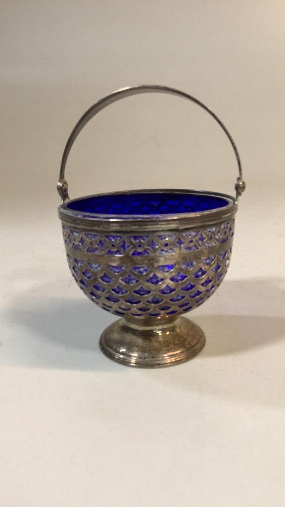 Tiffany and Co. Sterling Sugar Basket: 3.5 inch sterling basket with cobalt glass insert, fully marked for Tiffany..also 17033, 7642 handle is swing design..* light tarnish, insert needs cleaning Line Item # 57
