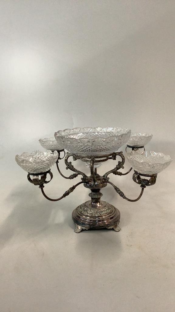 Silver Plate and Cut Crystal Epergne: 4 scrolling arms on a 13 inch tall pedestal , ball center, stepped center bowl, fan and hex cuts, saw tooth edge, 4 similar side bowls, ( one replaced) * rim chips Line Item # 101