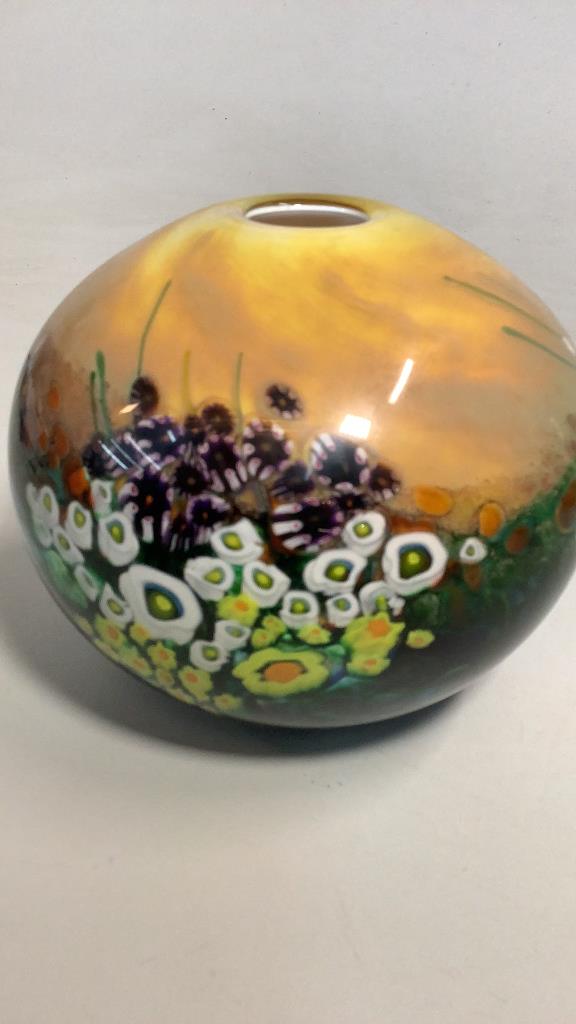Shawn Messenger Art Glass Vase: Signed Studio Art glass, Landscape series, dated 2002…7 x 6.5 round form in a millefiori floral design, with swirling golden sky… Line Item # 2