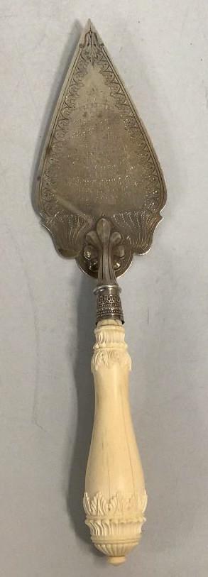 English Silver Presentation Cake Server: 13 inch engraved English Silver server with bone handle, presentation verse reads: To Miss Catherine Elizabeth King, June 1897, laying of The Memorial Stone, on land given by her, also Angus Silversmi