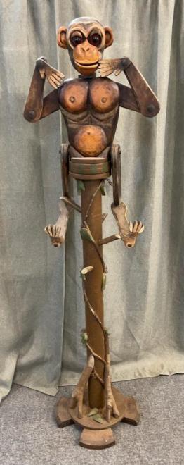 Folk Art Monkey in Tree: Articulated arms, legs, and head. Monkey rotates on base, e blessed w branches, vines & leaves 68” tall. Glass lives