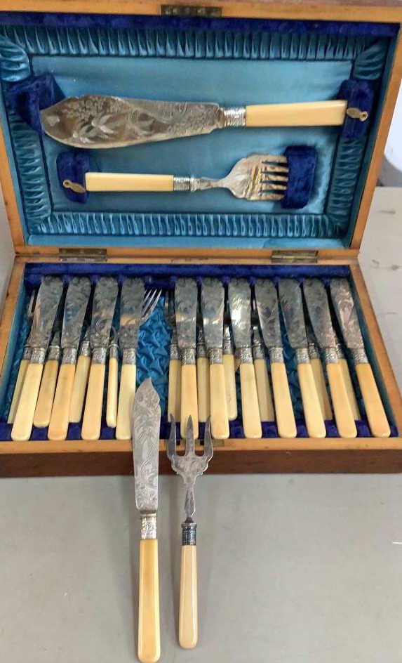 Victorian Plated Fish Sets: 26 piece set with embossed Asian design to blades, bone ? Handles presented in a satin lined case, 4 boxed 2 piece fish serving sets, one with unusual design to blade of a fisherman, large rolled hand