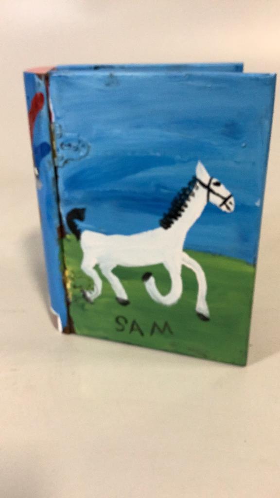 Outsider Art Clock in Book Shaped Case: Signed Sam, ( McMillan) with Horse on front cover, church on back, Big Apple Statue on Spine, holds a clock face to interior