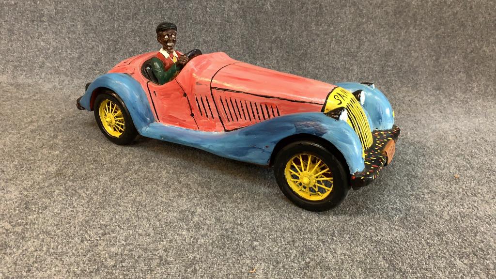 Sam the Dot Man McMillan, Folk Art Car: NC 1926-2018. Plastic composition, resin driver, head has been reattached, grille signed SAM, signature dots to front and rear fenders, paint loss throughout, 29 inches long